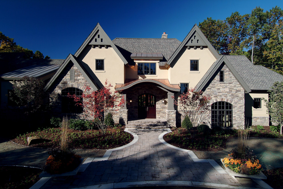 Design ideas for a large traditional house exterior in Grand Rapids with three floors.