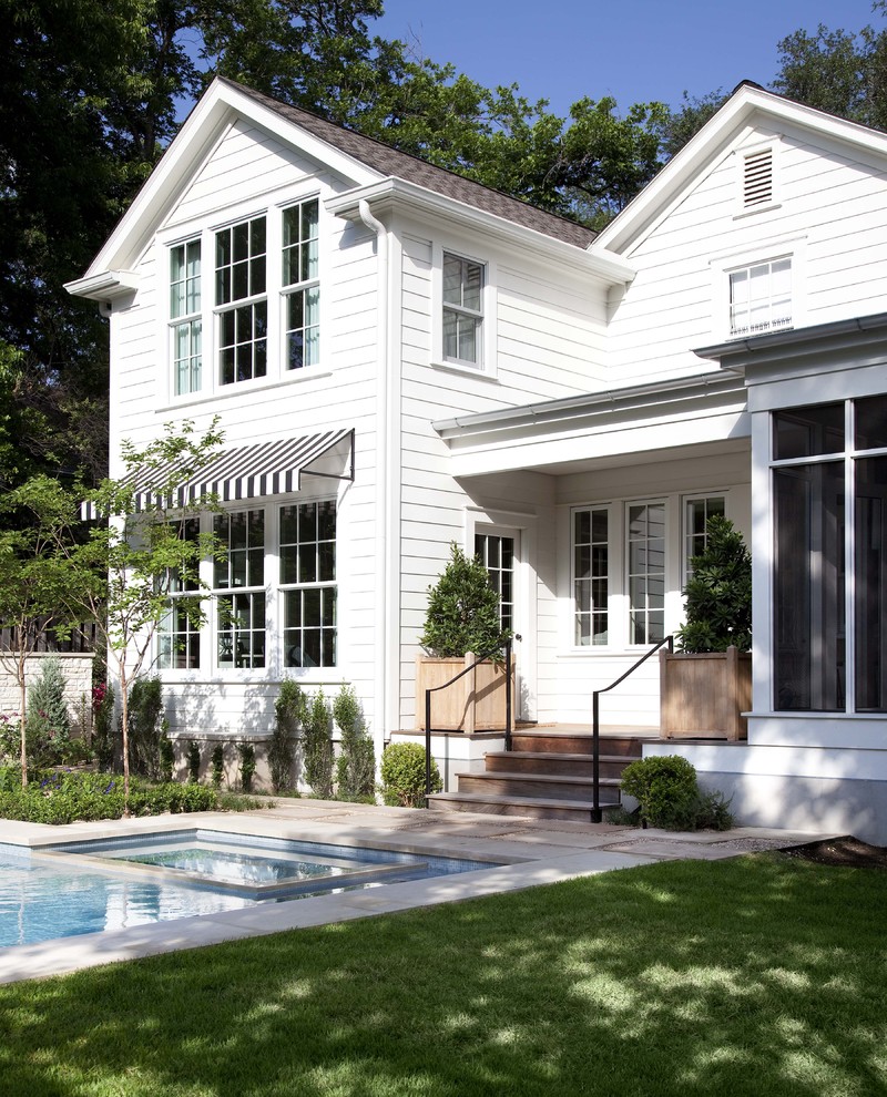 Example of a classic white two-story wood exterior home design in Austin