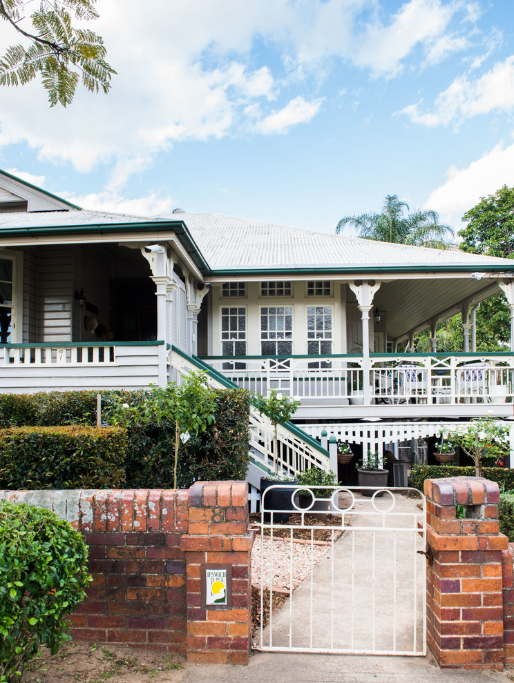 Large traditional gray two-story wood gable roof idea in Brisbane
