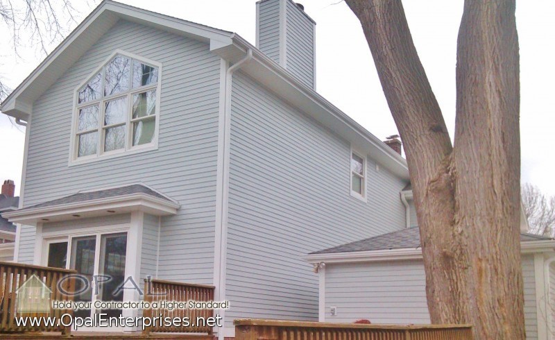 Photo of a medium sized and blue traditional two floor house exterior in Chicago with concrete fibreboard cladding.