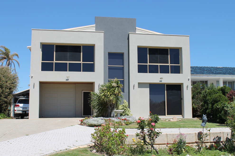 Inspiration for a large contemporary gray two-story concrete house exterior remodel in Perth with a metal roof