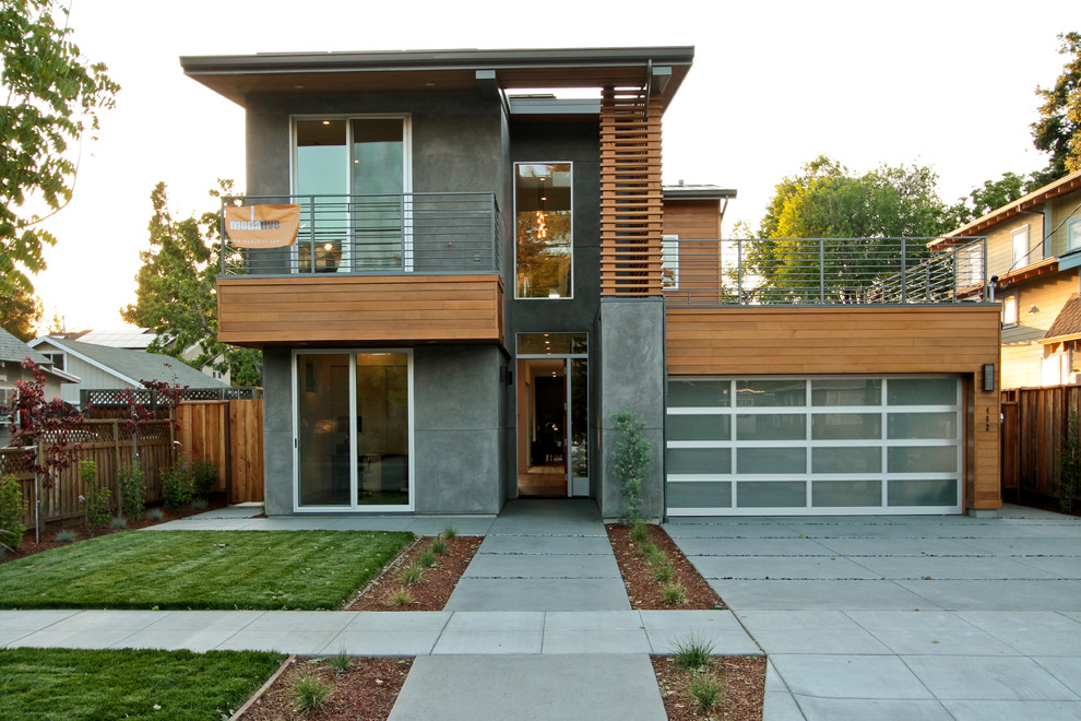 На фото: двухэтажный, серый дом в стиле модернизм с облицовкой из бетона и плоской крышей