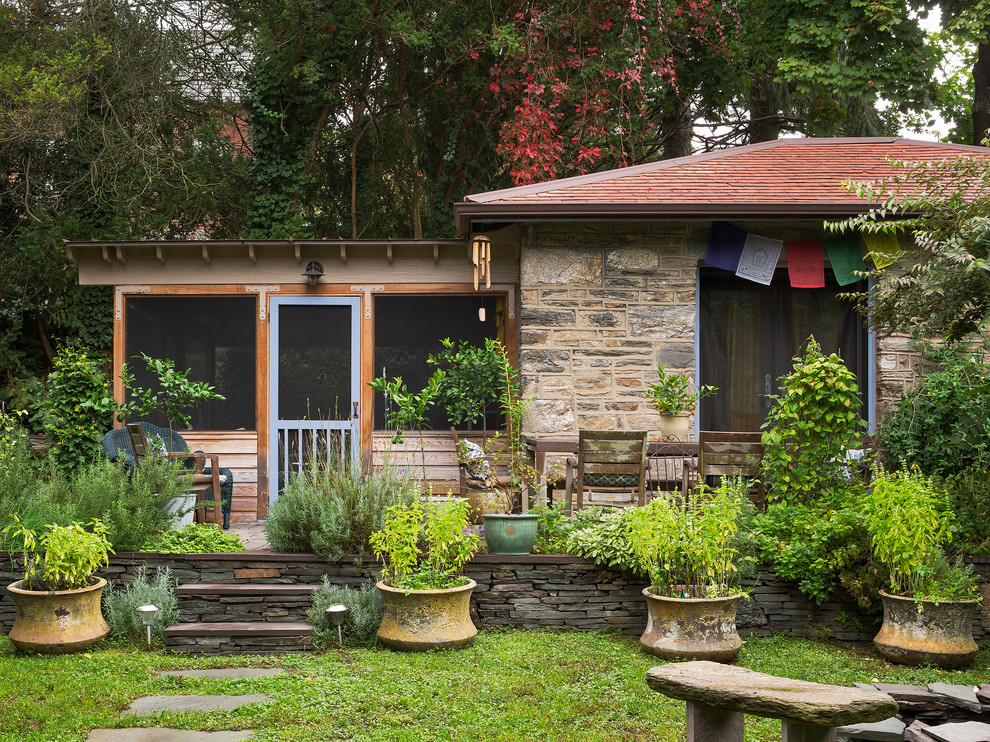 Design ideas for a rustic house exterior in Philadelphia with stone cladding.
