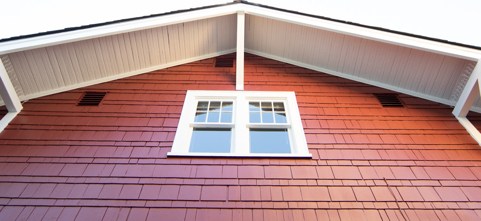 Example of a mid-sized arts and crafts red two-story wood gable roof design in Seattle