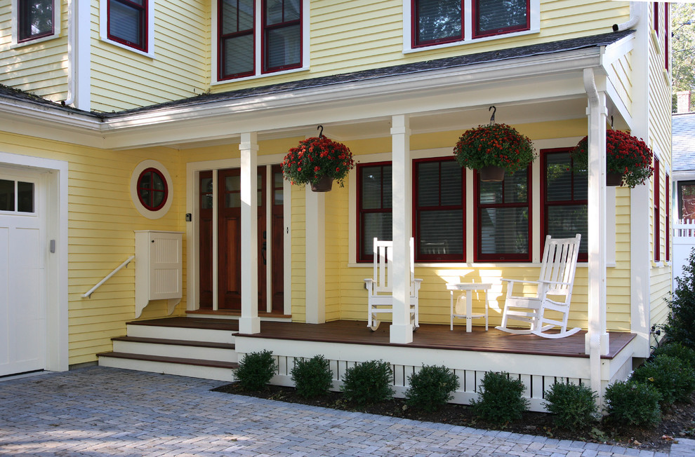 Mid-sized traditional yellow two-story wood exterior home idea in Boston with a shingle roof