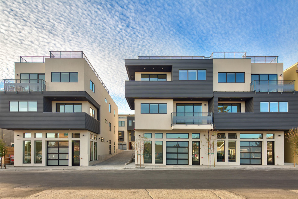 Ejemplo de fachada de casa pareada gris minimalista extra grande de tres plantas con revestimientos combinados, tejado plano y tejado de varios materiales