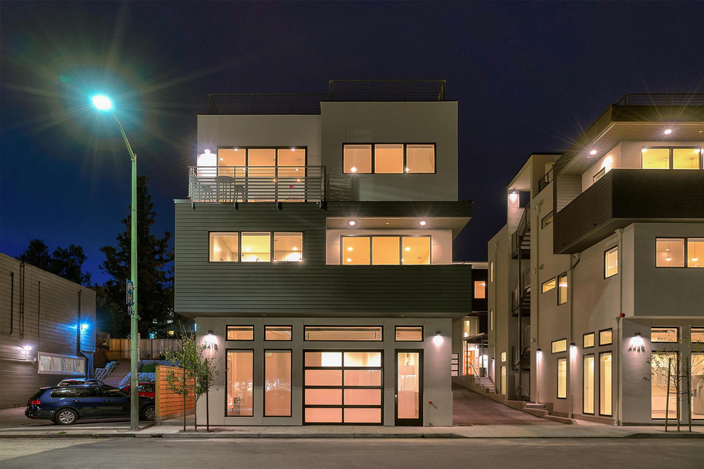 This is an example of an expansive and gey modern terraced house in San Francisco with three floors, mixed cladding, a flat roof and a mixed material roof.