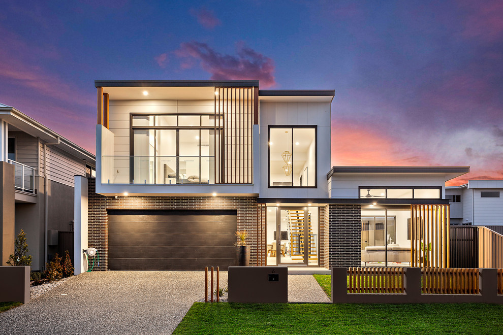 Mittelgroßes, Zweistöckiges Modernes Einfamilienhaus mit Flachdach und weißer Fassadenfarbe