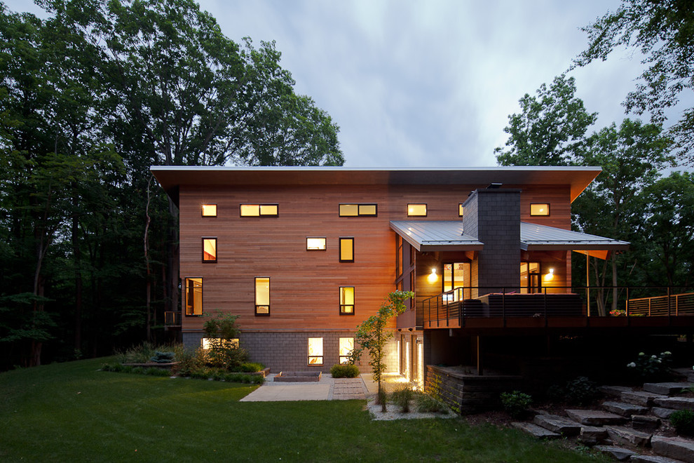 This is an example of a contemporary house exterior in Grand Rapids with wood cladding.