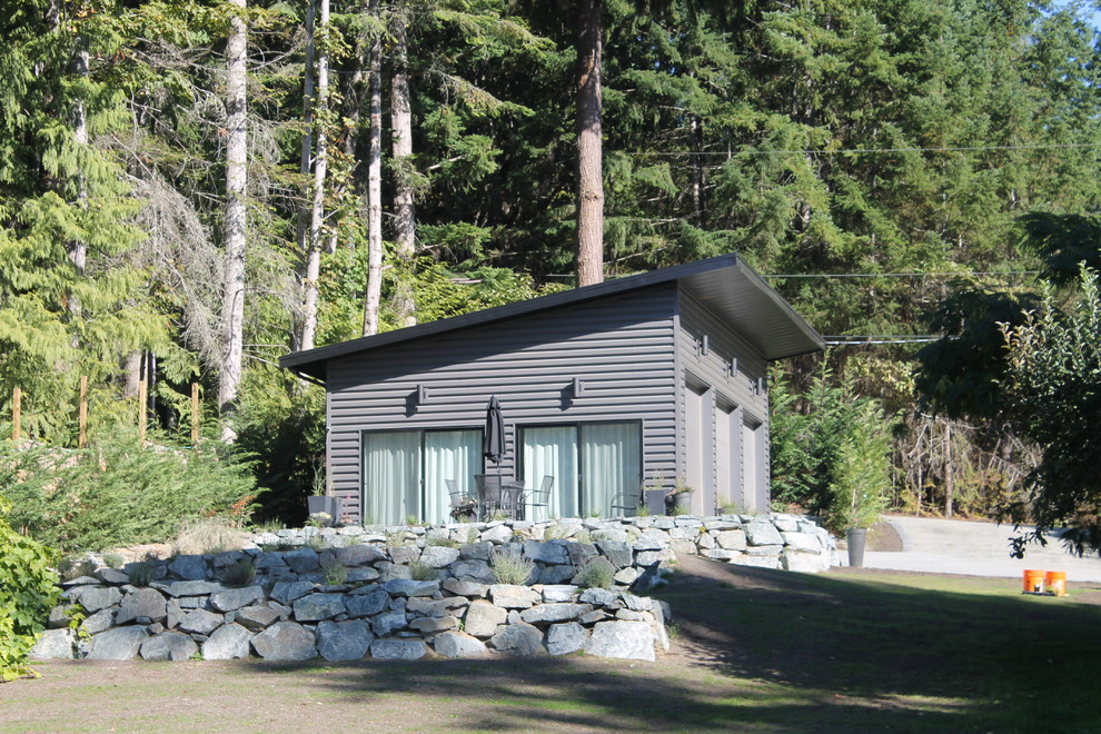 Mittelgroßes, Einstöckiges Modernes Haus mit Metallfassade, grauer Fassadenfarbe, Pultdach und Blechdach in Vancouver