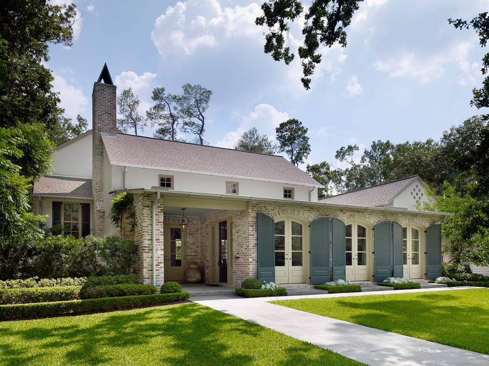 Example of a large classic two-story brick house exterior design in Houston