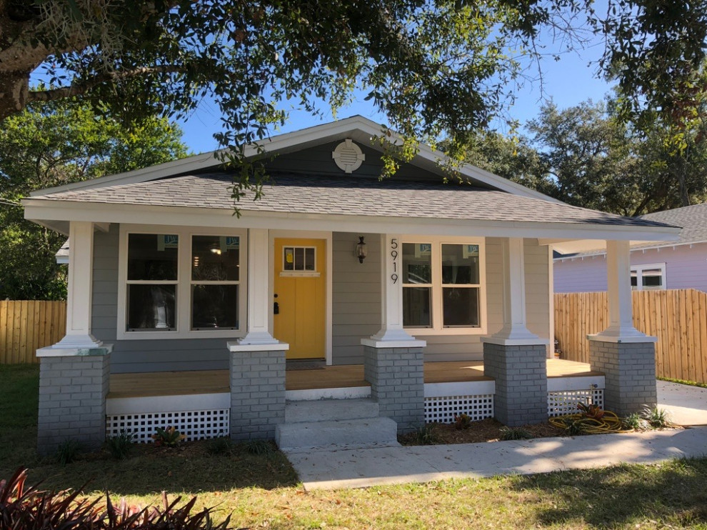 Mid-sized 1950s gray one-story mixed siding house exterior photo in Tampa with a shed roof and a shingle roof