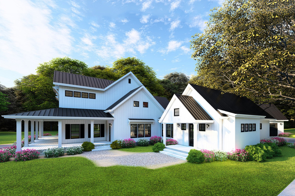 Example of a large farmhouse white two-story wood exterior home design with a metal roof