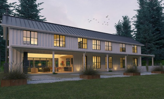 Cette photo montre une façade de maison blanche nature en bois de taille moyenne et à un étage avec un toit en métal.