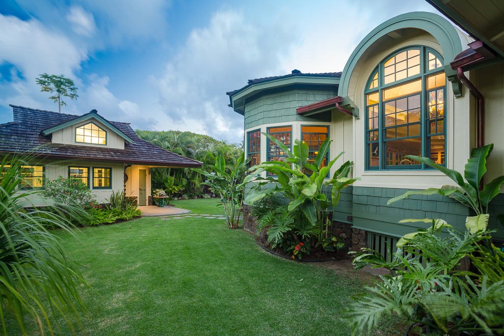 Inspiration for a mid-sized craftsman green one-story concrete fiberboard house exterior remodel in Hawaii with a hip roof and a shingle roof