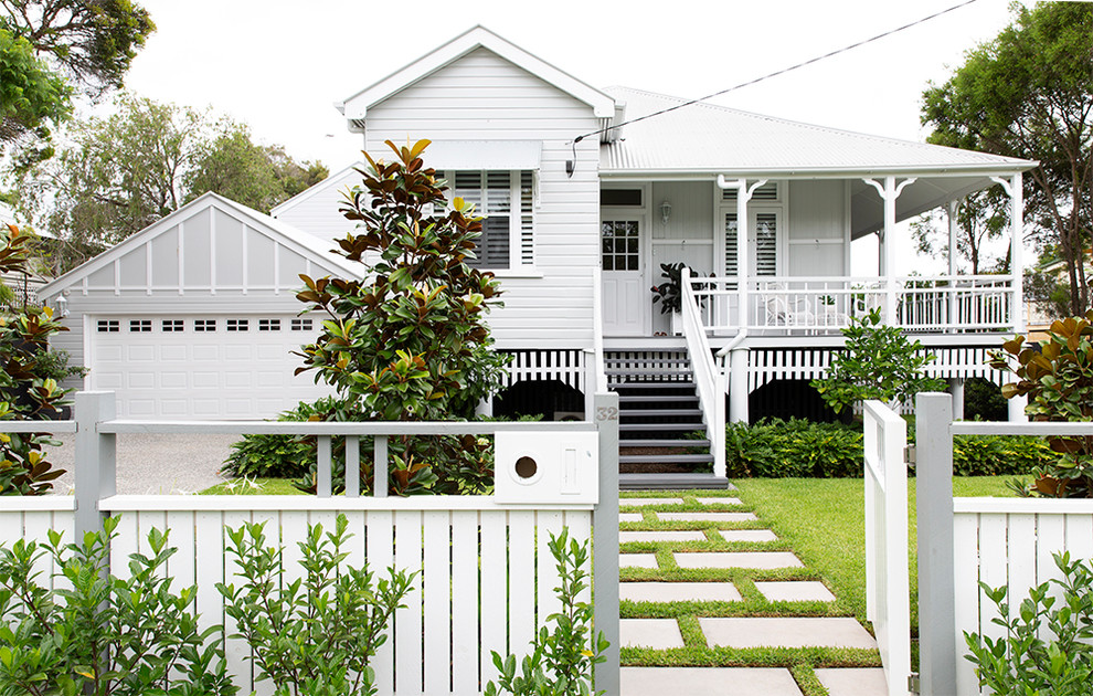Example of a mid-sized eclectic gray two-story wood exterior home design in Brisbane with a metal roof