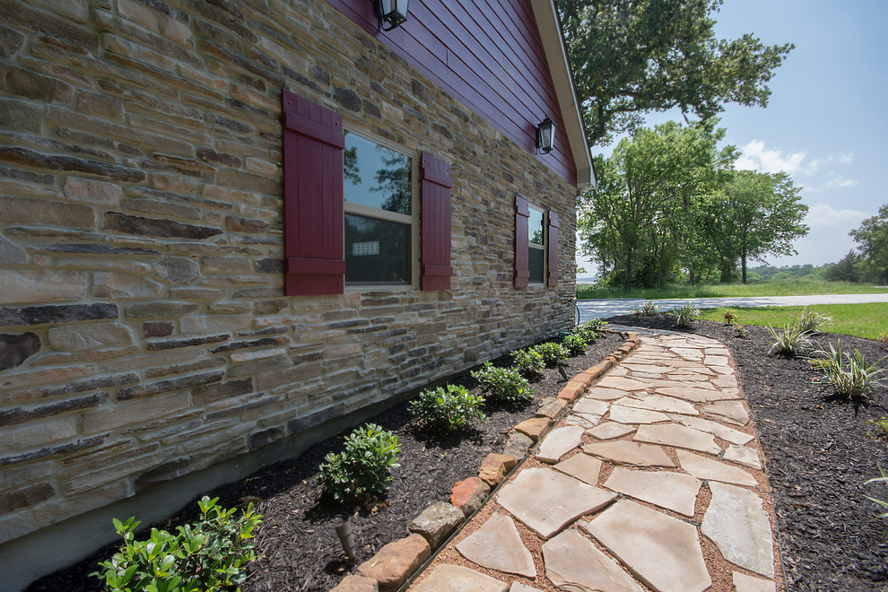 Photo of a medium sized and brown traditional bungalow house exterior in Austin with stone cladding.