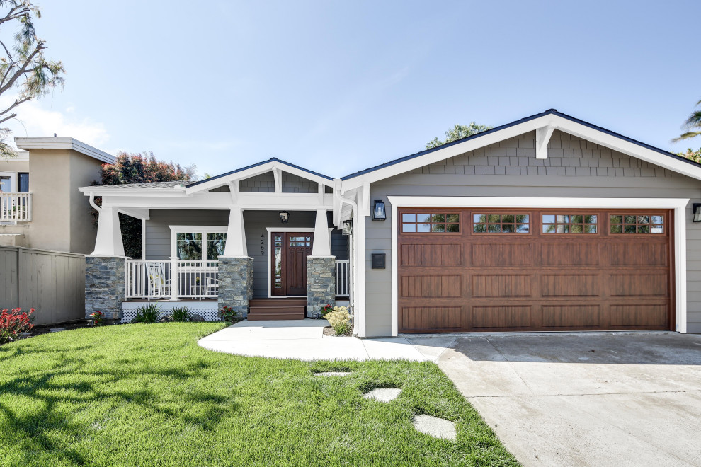 Photo of an expansive and gey contemporary bungalow detached house in San Diego with wood cladding, a flat roof and a shingle roof.