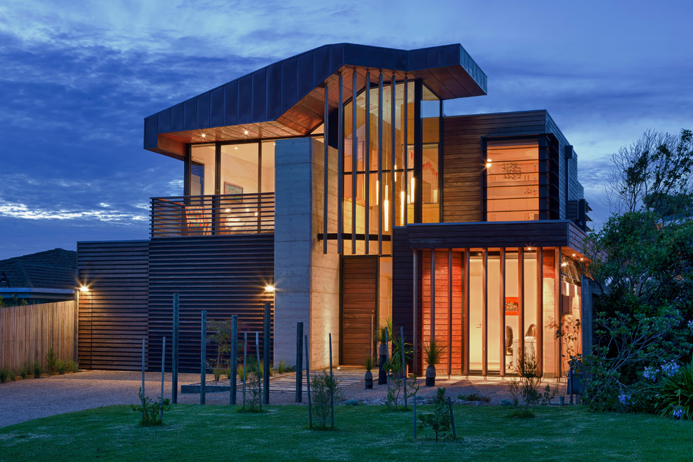 Design ideas for a brown contemporary two floor house exterior in Melbourne with wood cladding.