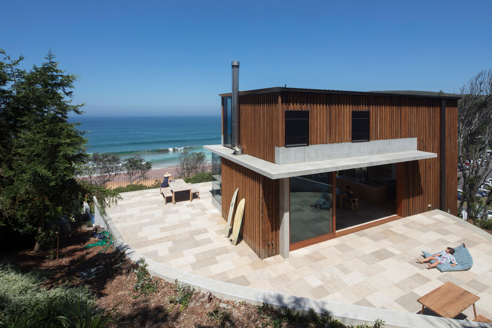 Example of a mid-sized beach style brown two-story wood exterior home design in Los Angeles with a metal roof