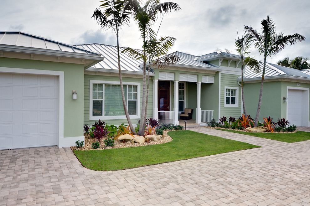 Inspiration for a medium sized and green world-inspired bungalow render house exterior in Miami.