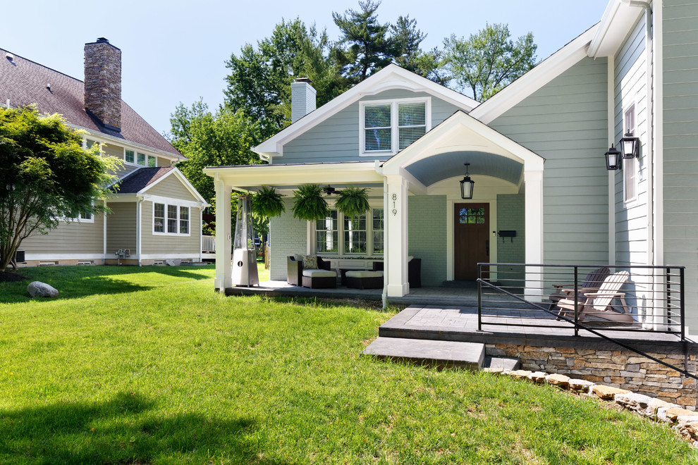Diseño de fachada de casa verde clásica de tres plantas con tejado a dos aguas y tejado de teja de madera