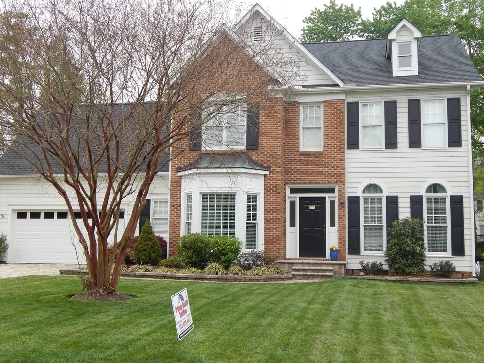 Example of a classic white two-story mixed siding exterior home design in Raleigh