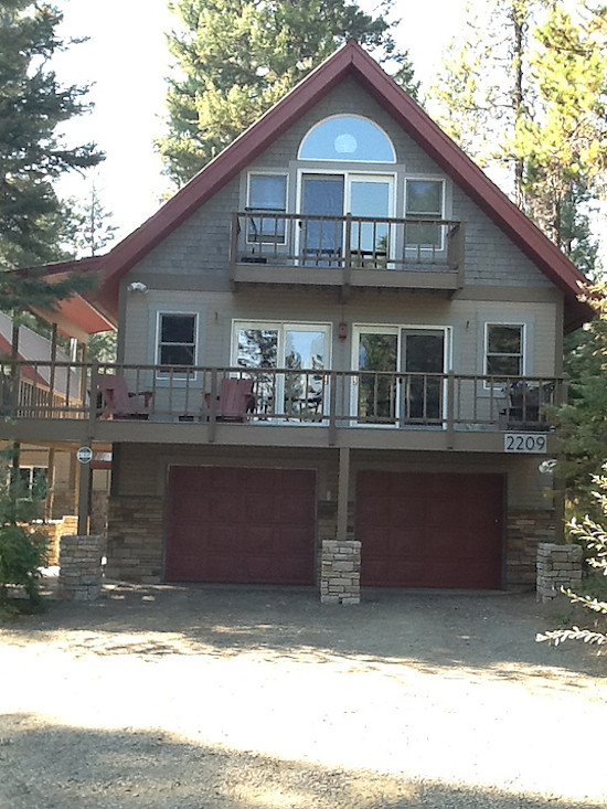 Example of a mid-sized mountain style green two-story wood exterior home design in Boise
