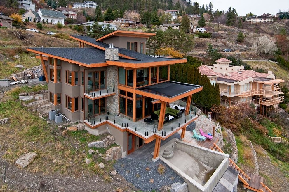 Inspiration for a large contemporary gray three-story mixed siding exterior home remodel in Vancouver