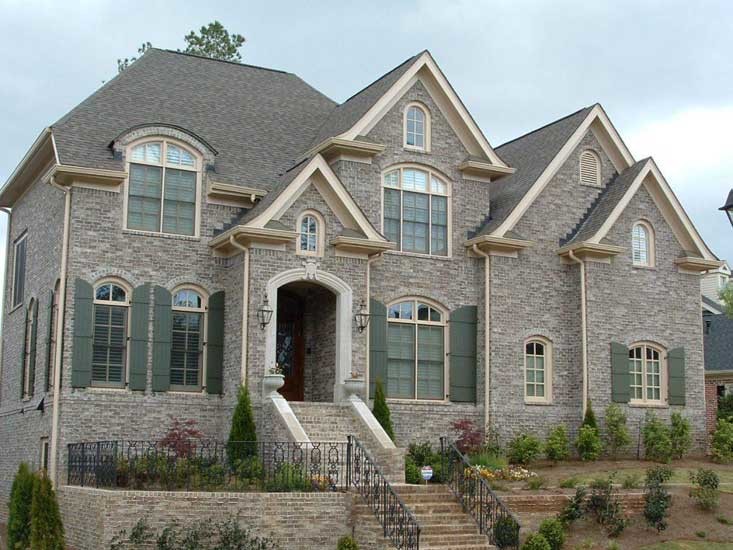 Example of a huge classic brown two-story brick exterior home design in Atlanta with a shingle roof