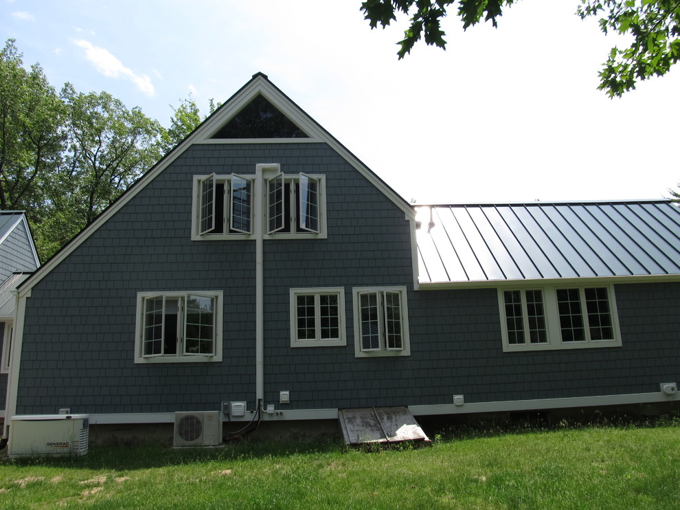 Example of a mid-sized classic gray one-story mixed siding gable roof design in Boston
