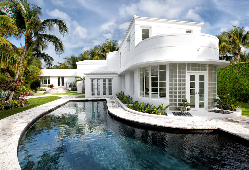 Trendy white two-story exterior home photo in Miami