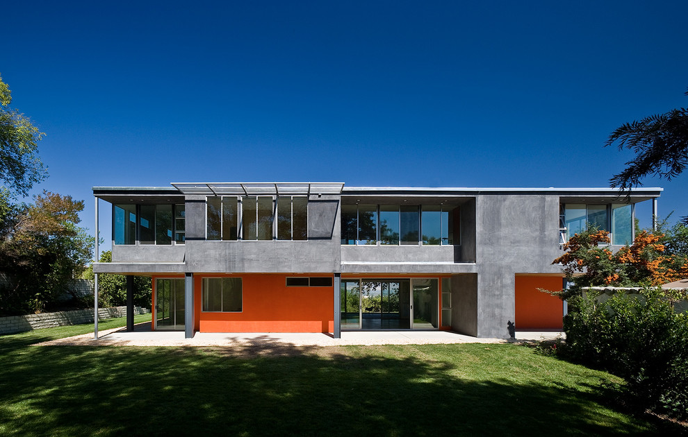 Example of a large minimalist red two-story concrete exterior home design in Los Angeles