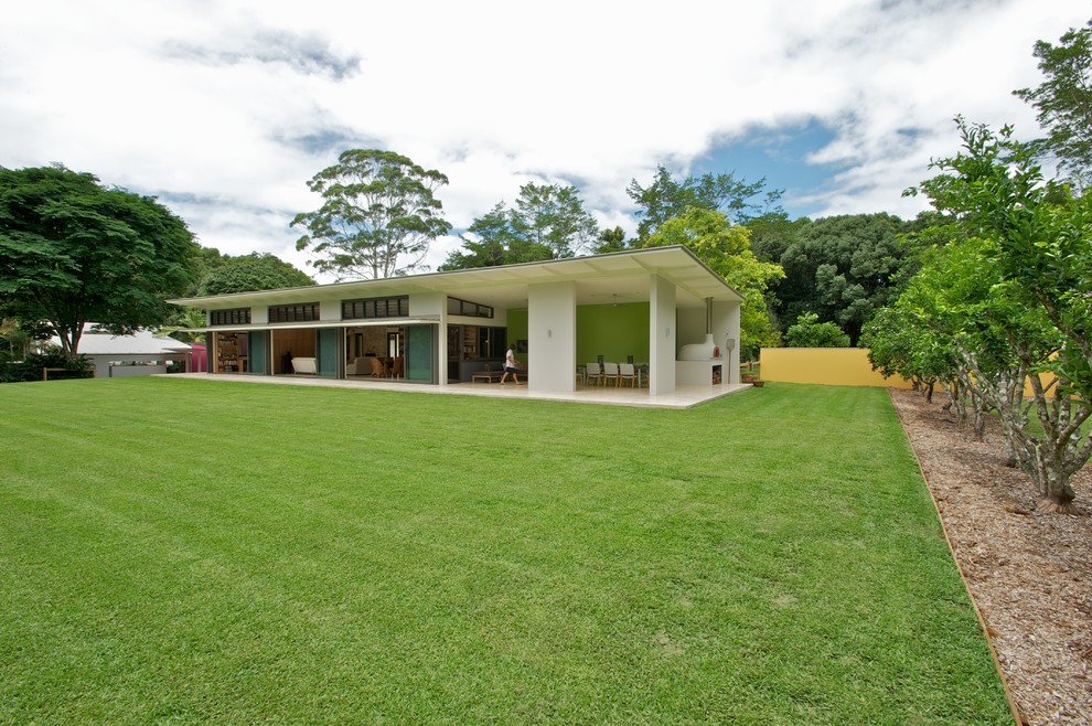 Example of a large trendy white one-story exterior home design in Sydney with a shed roof