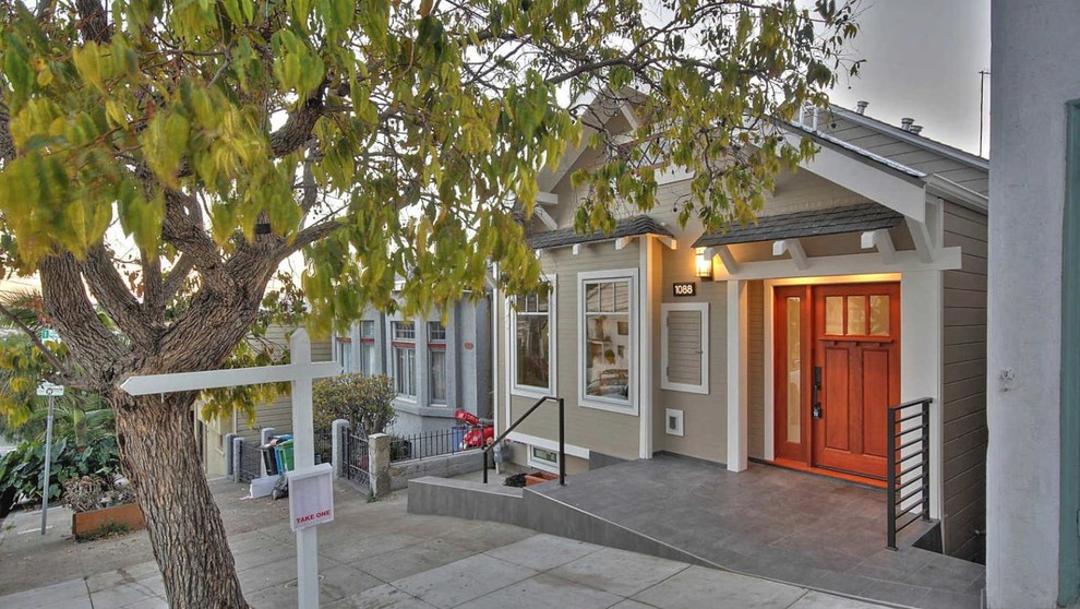 Example of a mid-sized arts and crafts beige two-story wood exterior home design in San Francisco