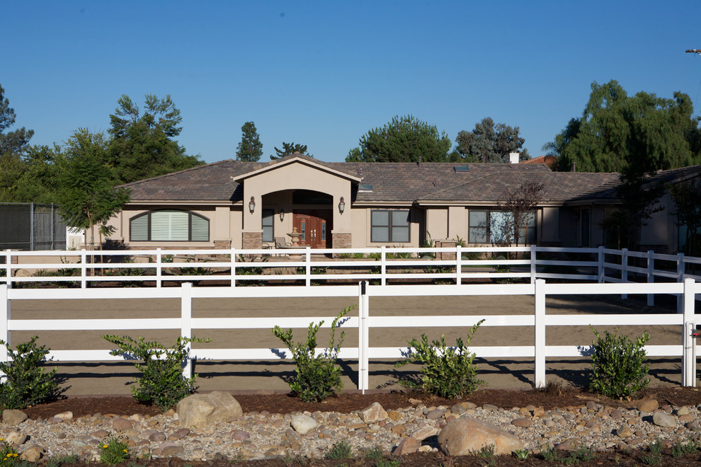 This is an example of a brown traditional bungalow render house exterior in San Diego.