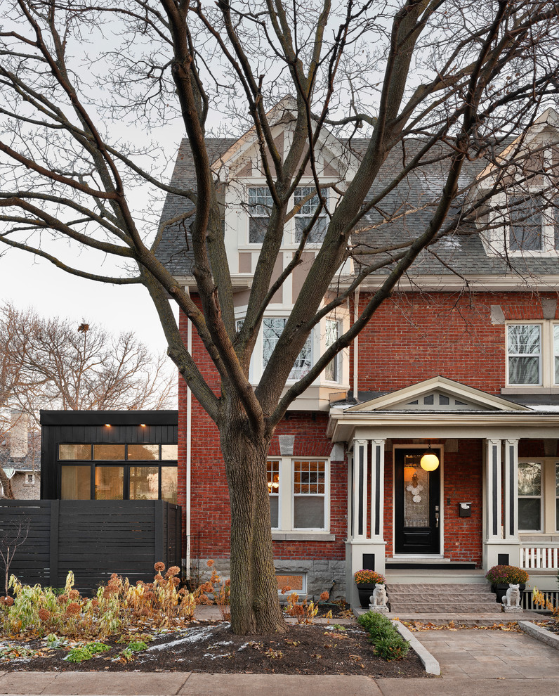 This is an example of a red classic two floor brick detached house in Ottawa with a pitched roof and a shingle roof.