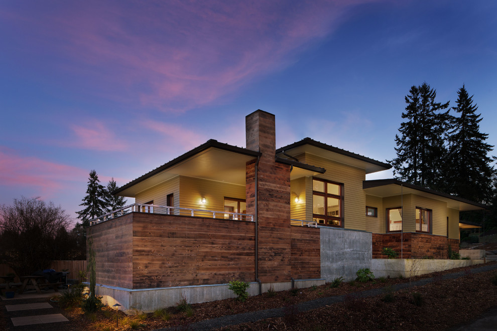 Photo of a medium sized and yellow contemporary two floor detached house in Seattle with mixed cladding, a lean-to roof and a metal roof.
