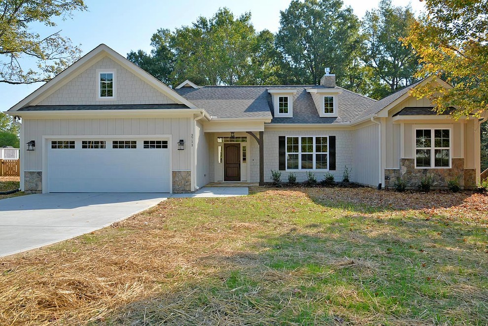 Medium sized and beige traditional bungalow house exterior in Raleigh.