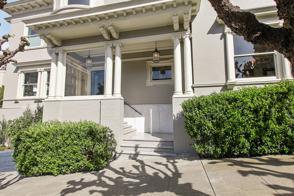 Huge ornate gray three-story wood exterior home photo in San Francisco with a shingle roof