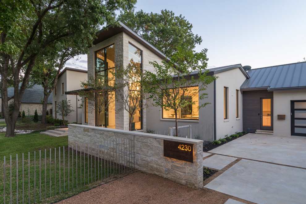 Large trendy beige two-story mixed siding exterior home photo in Dallas with a shed roof