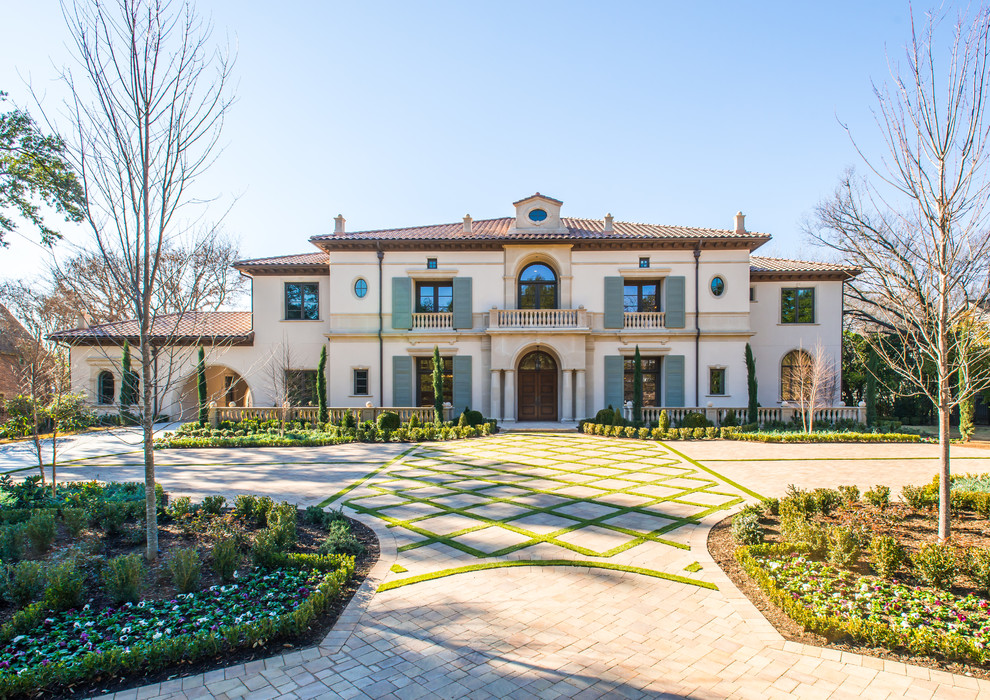 Example of a large tuscan two-story stucco exterior home design in Dallas