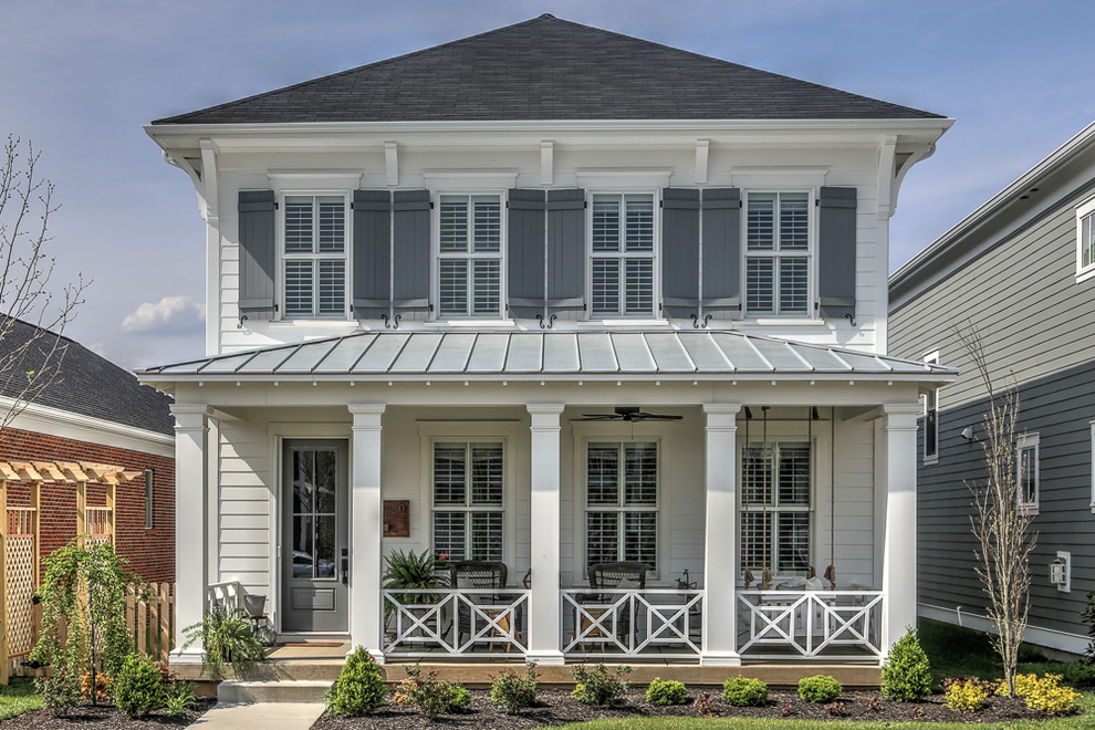 Inspiration for a white coastal two floor detached house in Louisville with a hip roof.