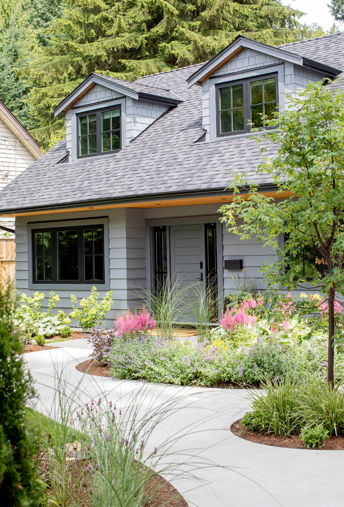 Example of a mid-sized trendy gray two-story wood exterior home design in Vancouver with a shingle roof