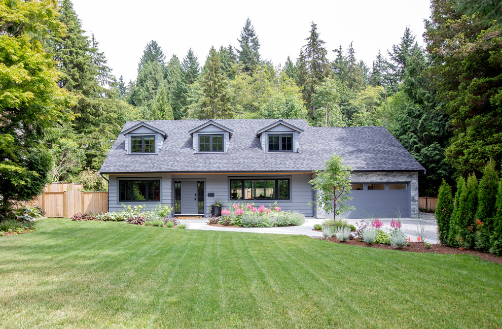 Ejemplo de fachada de casa gris actual de tamaño medio de dos plantas con revestimiento de madera, tejado a dos aguas y tejado de teja de madera