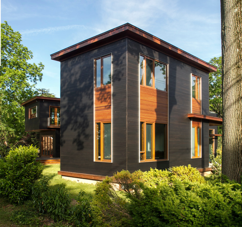 Imagen de fachada gris minimalista grande de dos plantas con revestimientos combinados y tejado plano