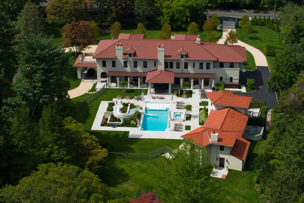 Example of a huge tuscan beige three-story exterior home design in New York