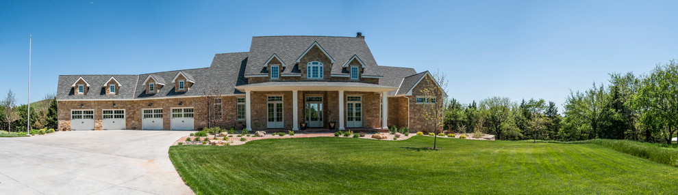 Large three-story stone exterior home photo in Other with a shingle roof