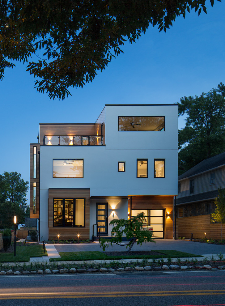 Idée de décoration pour une grande façade de maison blanche design à deux étages et plus avec un toit plat.