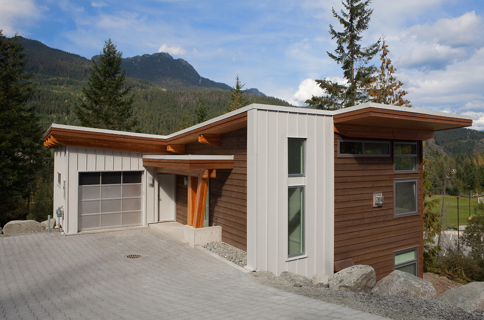 Inspiration for a medium sized and brown contemporary two floor house exterior in Vancouver with mixed cladding.
